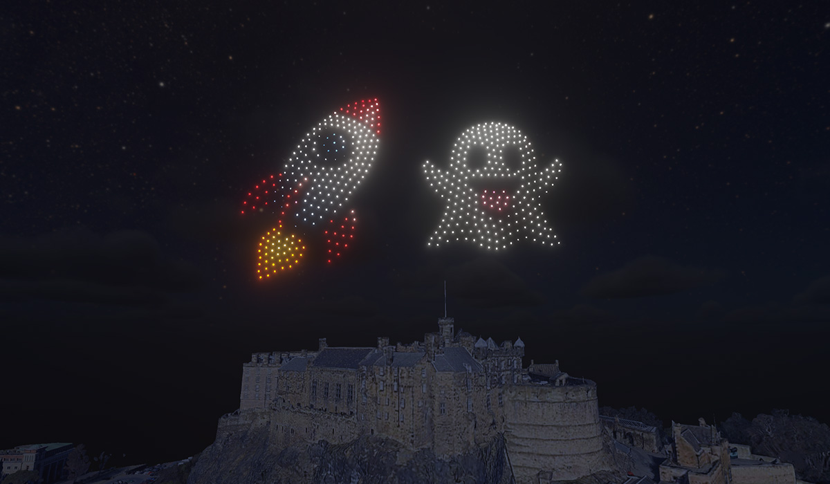 An emoji rocket and ghost made from 500 drones